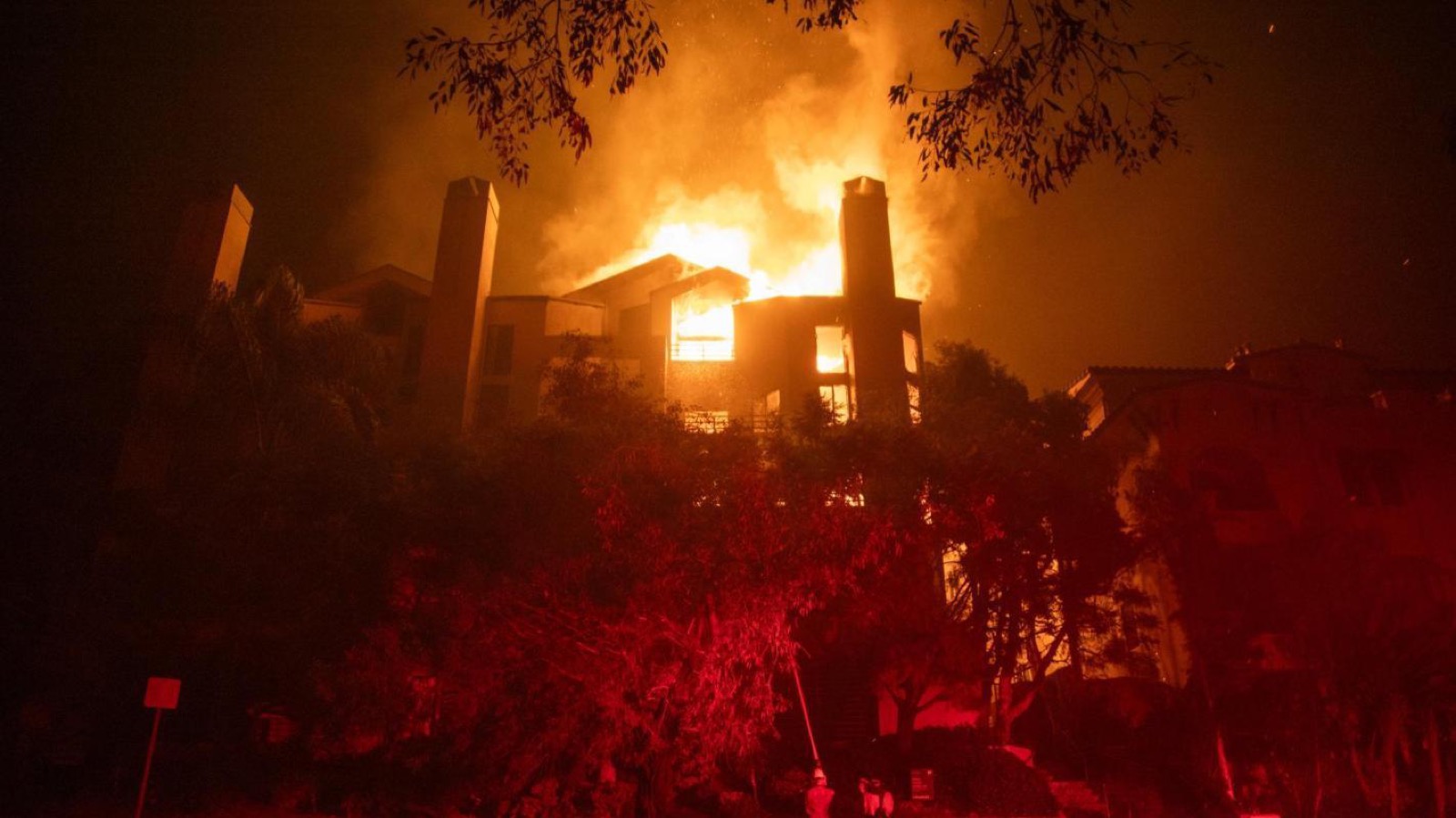 California home fully engulfed in wildfire flames at night